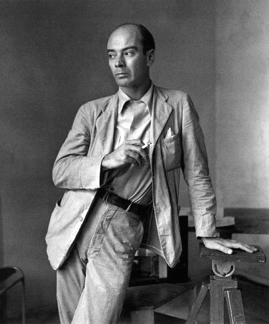 Clifford Coffin, debout dans un studio, une cigarette à la main